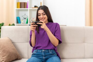 young-girl-playing-games-using-smartphone